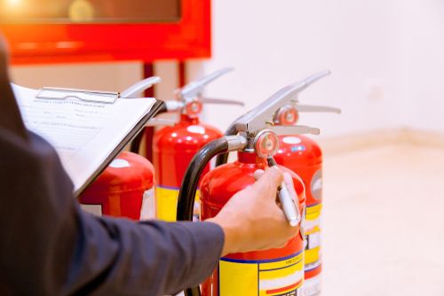 employee checking fire extinguishers