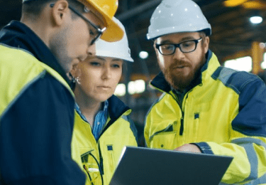 three employees go over safety documents
